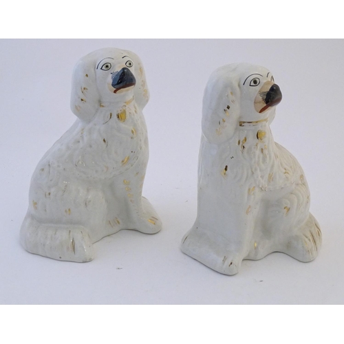60 - A pair of Staffordshire pottery spaniel dogs with gilt highlights. Approx. 10