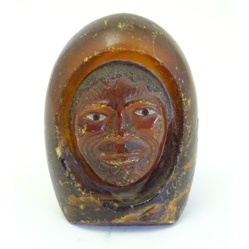 1114 - A Maori carved resin model of the head of a man with painted eyes and Moko facial tattoos. Approx. 4... 