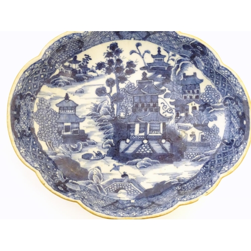 54 - An Oriental blue and white plate with stylised peony detail, and stylised scrolling flower motifs to... 