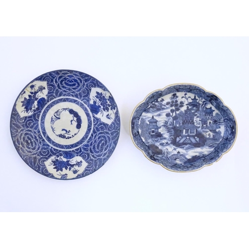 54 - An Oriental blue and white plate with stylised peony detail, and stylised scrolling flower motifs to... 