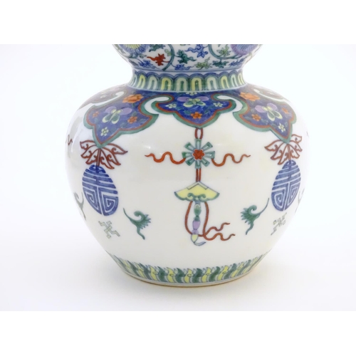 1 - A Chinese double gourd vase with doucai style decoration with scrolling floral and foliate detail. C... 