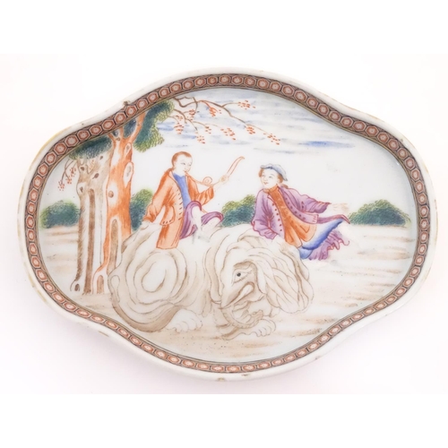 20 - A Chinese export dish of quatrefoil form depicting a landscape scene with a man playing a horn seate... 