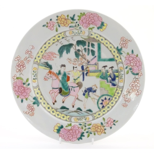 21 - A Chinese famille rose plate depicting a landscape scene with a figure on horse back with an attenda... 