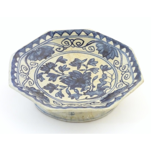 16 - An Oriental blue and white footed dish, the octagonal top decorated with floral and foliate detail. ... 