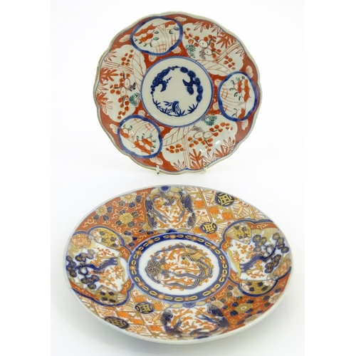 2 - Two Oriental plates, one decorated with panelled detail depicting landscape scenes. The other decora... 