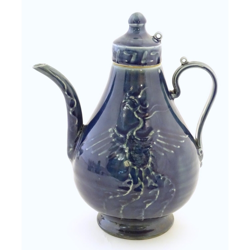 30 - A Chinese pear shaped teapot with phoenix bird decoration to body. Approx. 8 3/4