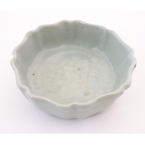 31 - A Chinese celadon brush wash pot with a scalloped edge. Character marks under. Approx. 1 1/2