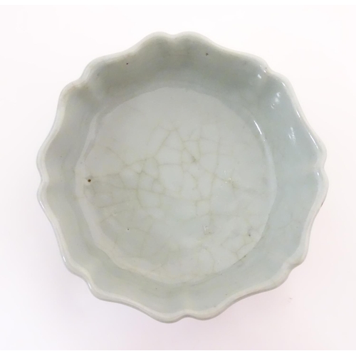 31 - A Chinese celadon brush wash pot with a scalloped edge. Character marks under. Approx. 1 1/2