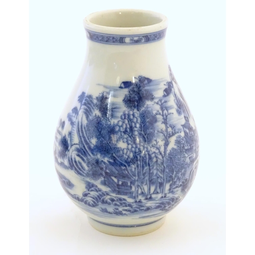 35 - A Chinese blue and white vase decorated with a landscape scene with mountains, pagodas, figures in b... 