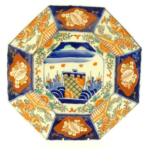 39 - A Japanese octagonal plate in the Imari palette decorated with birds, flowers and foliage, with cent... 