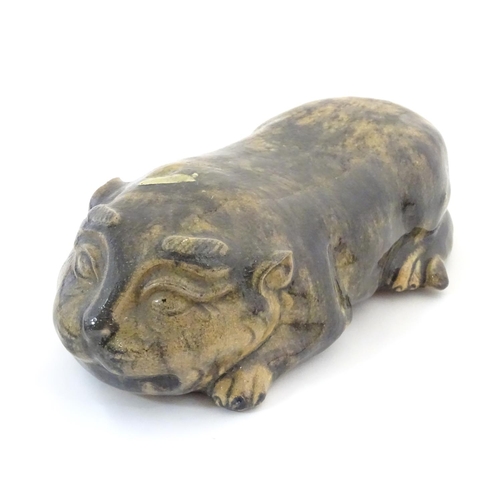 47 - An Oriental model of a recumbent animal, possibly a cat. Marked under. Approx. 9