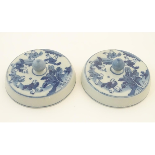 53 - Two Chinese blue and white lids with figures in a landscape. Approx. 6 1/2