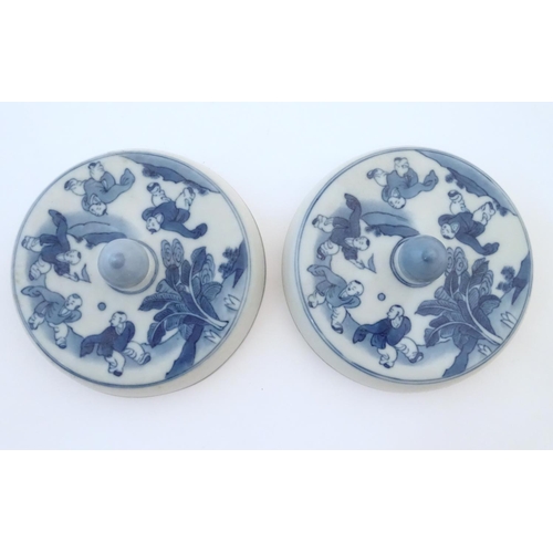 53 - Two Chinese blue and white lids with figures in a landscape. Approx. 6 1/2