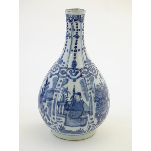7 - A Chinese blue and white Kraak style bottle vase with panelled decoration depicting figures and gard... 