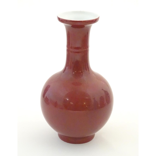 8 - A Chinese bottle vase with a flared rim. Character marks under. Approx. 7 3/4