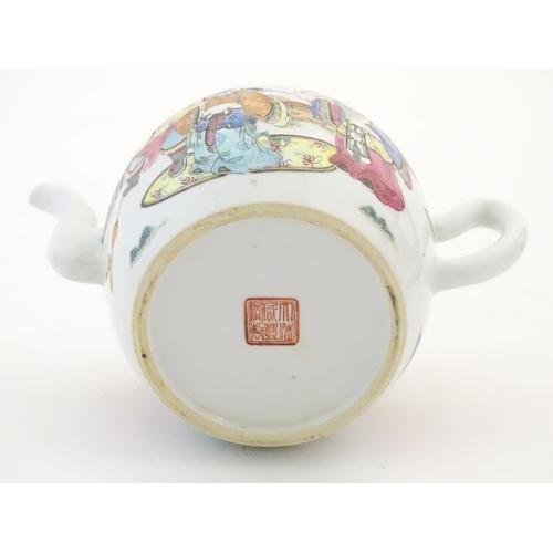 27 - A Chinese famille rose teapot depicting scholars with attendants on a terrace with a mountainous lan... 