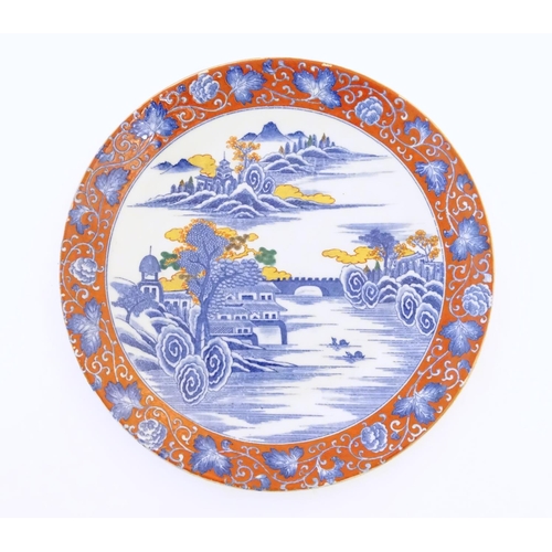 54A - A Japanese charger depicting a mountain landscape scene with a river, boats, a bridge, pagoda style ... 