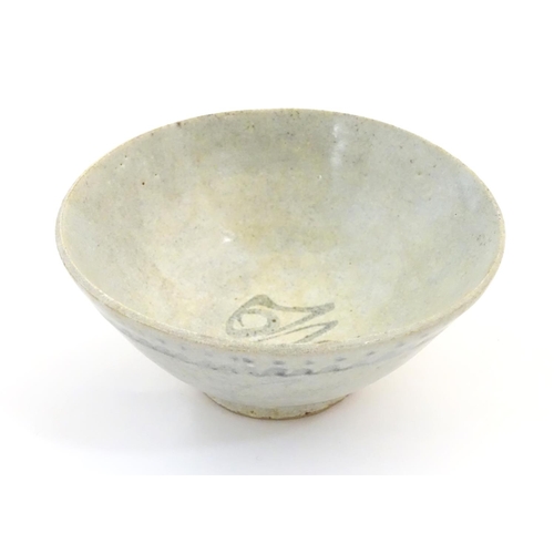 13 - An Oriental earthenware bowl of tapering form with brushwork detail. Approx. 2 1/4