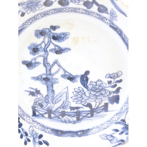 10A - A Chinese blue and white plate with a lobed rim decorated with a landscape scene with trees and flow... 