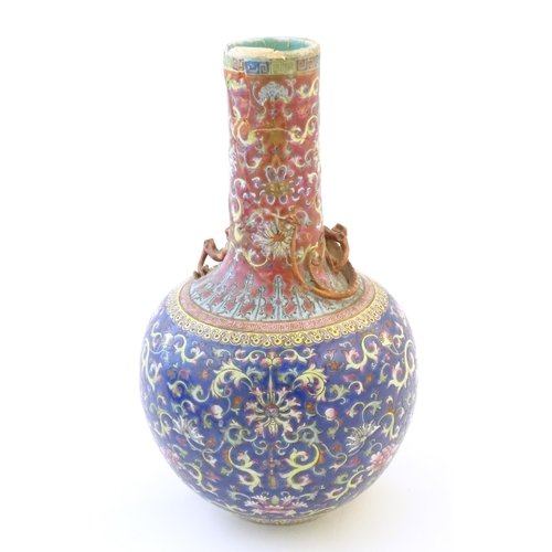 8 - A Chinese bottle vase with scrolling floral and foliate detail, and applied dragon decoration to nec... 
