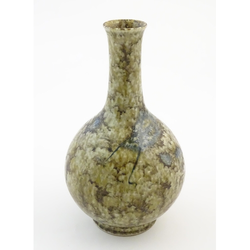 14 - A Chinese bottle vase with a mottled glaze decorated with a stylised dragon face and claws, and Char... 