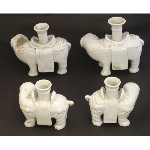 42 - Four Chinese blanc de chine bud vases modelled as elephants. Largest 6 1/2