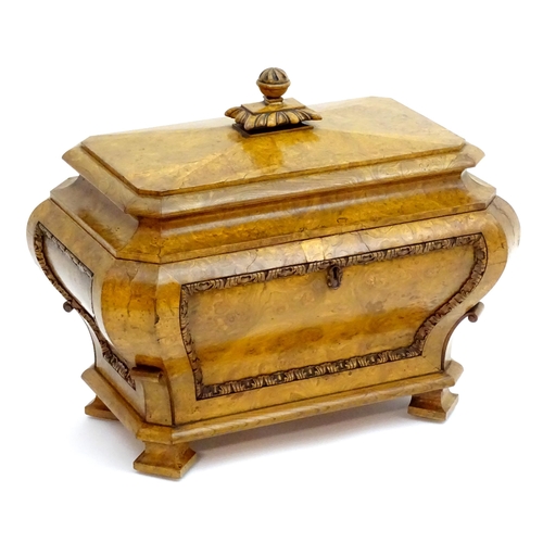 A Regency burr elm sarcophagus wine cooler, having a carved handle above a moulded lid and carved front and escutcheon. 31" wide x 19" deep x 24" high.