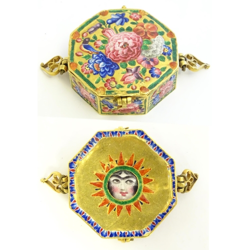 A 19thC Islamic / Persian miniature amulet bazuband Quran / Qur'an / Koran holder / box of octagonal form with enamel and hand painted decoration depicting flowers and foliage, with hand painted face in a sunburst border verso. Approx. 1 3/4" wide