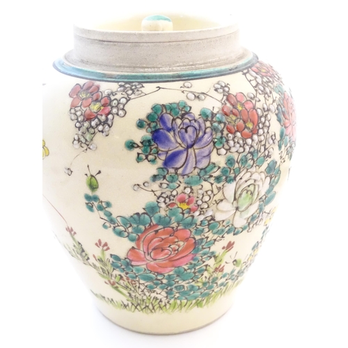 47 - An Oriental ginger jar and cover with inner lid, decorated with flowers and foliage. Possibly Japane... 