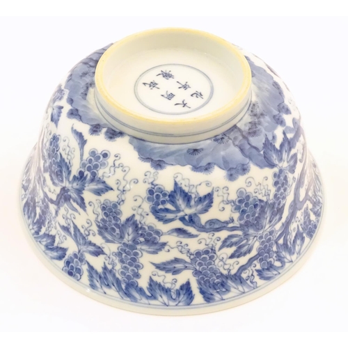 50 - A Chinese blue and white bowl decorated with vine leaves and grapes. Character marks under. Approx. ... 