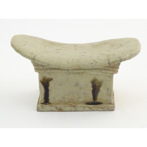 54 - An Oriental stoneware neck pillow / headrest with architectural / building detail. Approx. 4 1/4