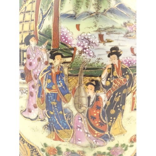 56 - A Japanese model of an egg decorated with four ladies on a garden terrace playing musical instrument... 