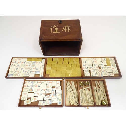 1295 - An early to mid 20thC Chinese Mahjong set, the mahogany case enclosing five drawers containing tiles... 