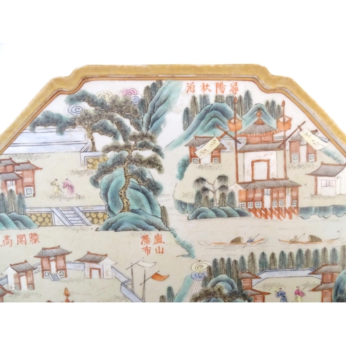 1 - A Chinese famille rose panel of octagonal form decorated with pagoda style buildings, trees, figures... 