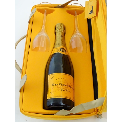 2180 - A cased bottle of Veuve Cliquot Ponsardin 'Veuve Traveller', the case containing one 75cl bottle and... 