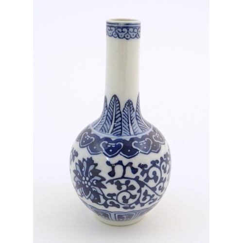 26 - A small Chinese blue and white bottle vase with stylised floral and foliate detail. Character marks ... 