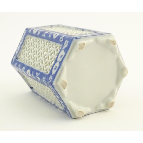 4 - An Oriental hexagonal pot pourri holder with blue and white floral detail and reticulated panels. Ap... 