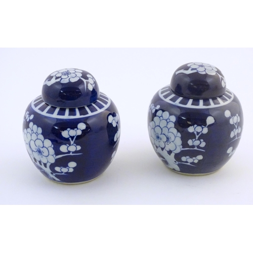 57 - Two Chinese blue and white ginger jars with prunus blossom decoration. Approx. 6 1/4