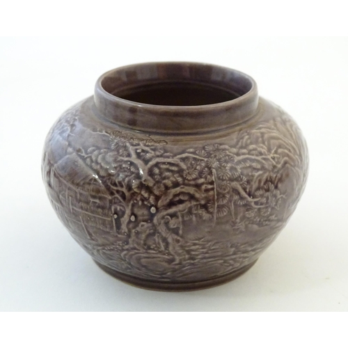 6 - A small Chinese pot of squat form with cast landscape detail. Character marks under. Approx. 2 1/8