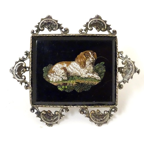 A 19thC Italian micromosiac brooch depicting a recumbent spaniel dog within a silver mount. In the Manner of Luigi Cavaliere Moglia, c1830. Approx. 2 1/2" wide