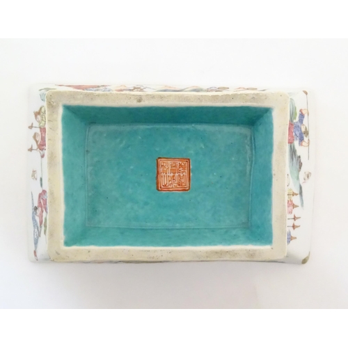 7 - A Chinese footed dish of rectangular form decorated with imperial style figures and attendants on ho... 