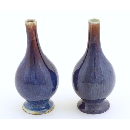 15 - A pair of Oriental high fired bottle vases. Approx. 5 3/4