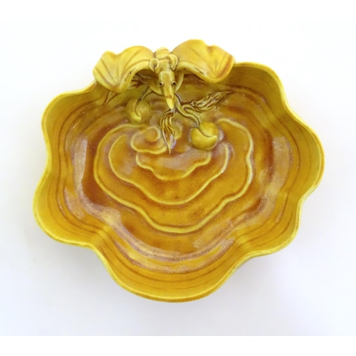 18 - A Chinese fluted edged yellow brush wash dish with relief bat and fruit decoration. Character marks ... 