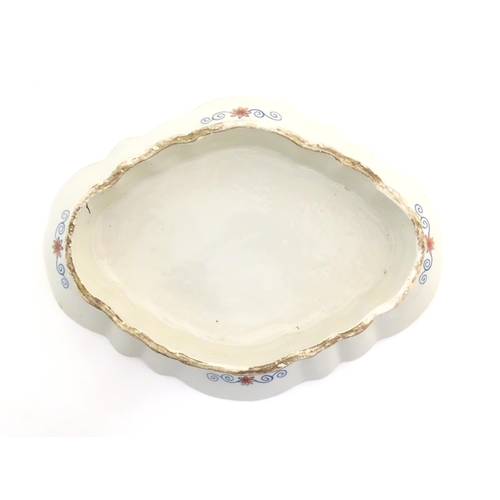 20 - A Chinese export famille rose footed serving dish of lozenge form in the tobacco leaf pattern with f... 