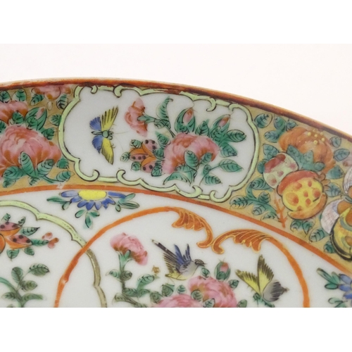 23 - A Chinese / Cantonese famille rose charger decorated with flowers, foliage, birds, butterflies, etc.... 