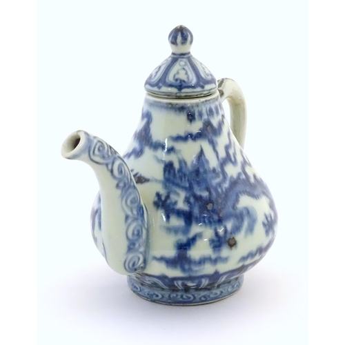 50 - A Chinese blue and white teapot decorated with dragons amongst stylised scrolling clouds. Approx. 6