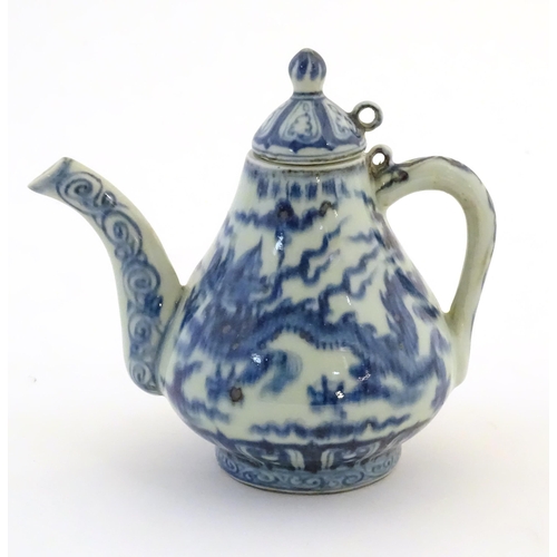 50 - A Chinese blue and white teapot decorated with dragons amongst stylised scrolling clouds. Approx. 6