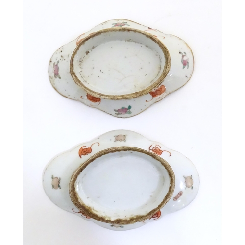 51 - Two Chinese famille rose footed dishes of lozenge form, one decorated with two figures in a landscap... 
