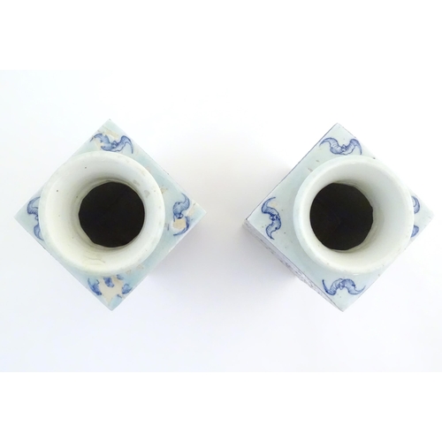 55 - A matched pair of Chinese blue and white Cong shaped vases, with a tall square tapering body with fl... 