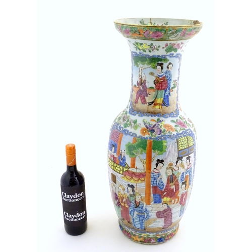 66 - A large Chinese / Cantonese famille rose baluster vase with a flared rim decorated with panels depic... 
